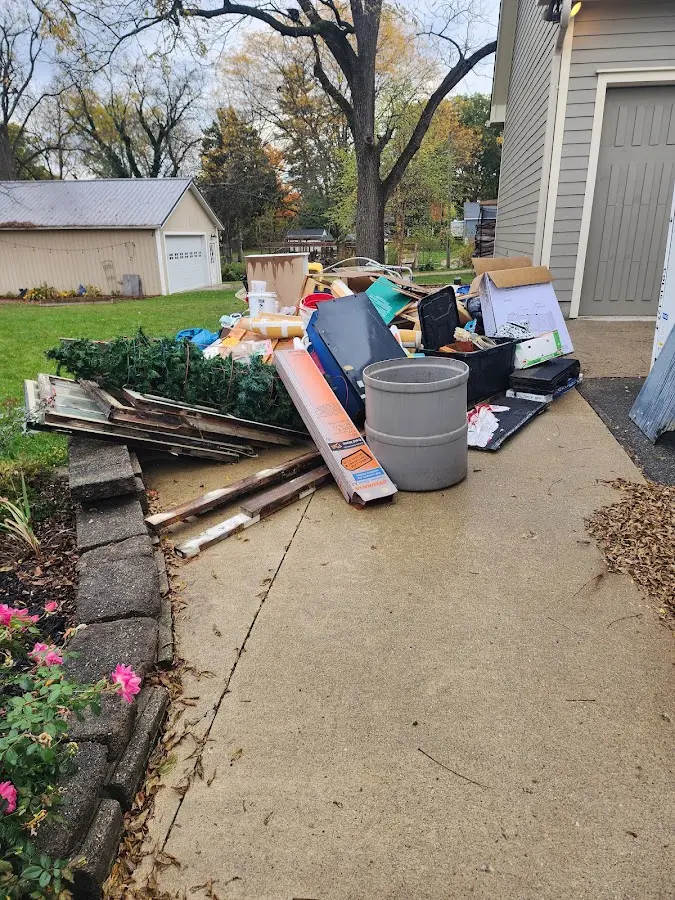 Dumpster being loaded with debris for Estate Cleanout Dumpster Rental in Muscatine